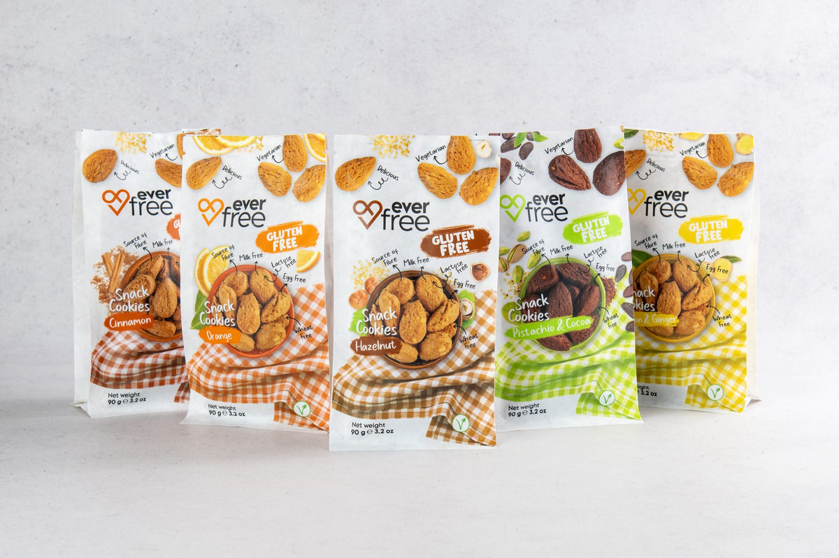 Five EverFree gluten-free cookie bags standing in a row, one of each flavour